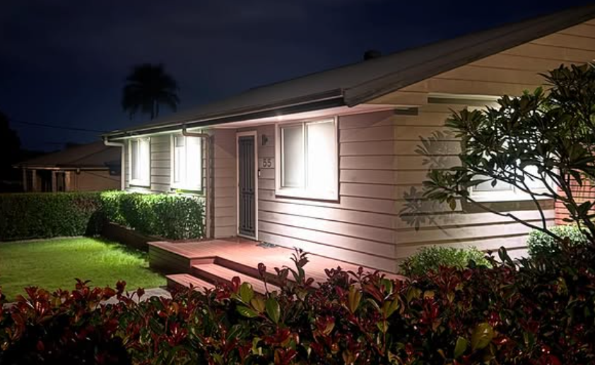Home exterior with JTH Electrical downlight installation at night